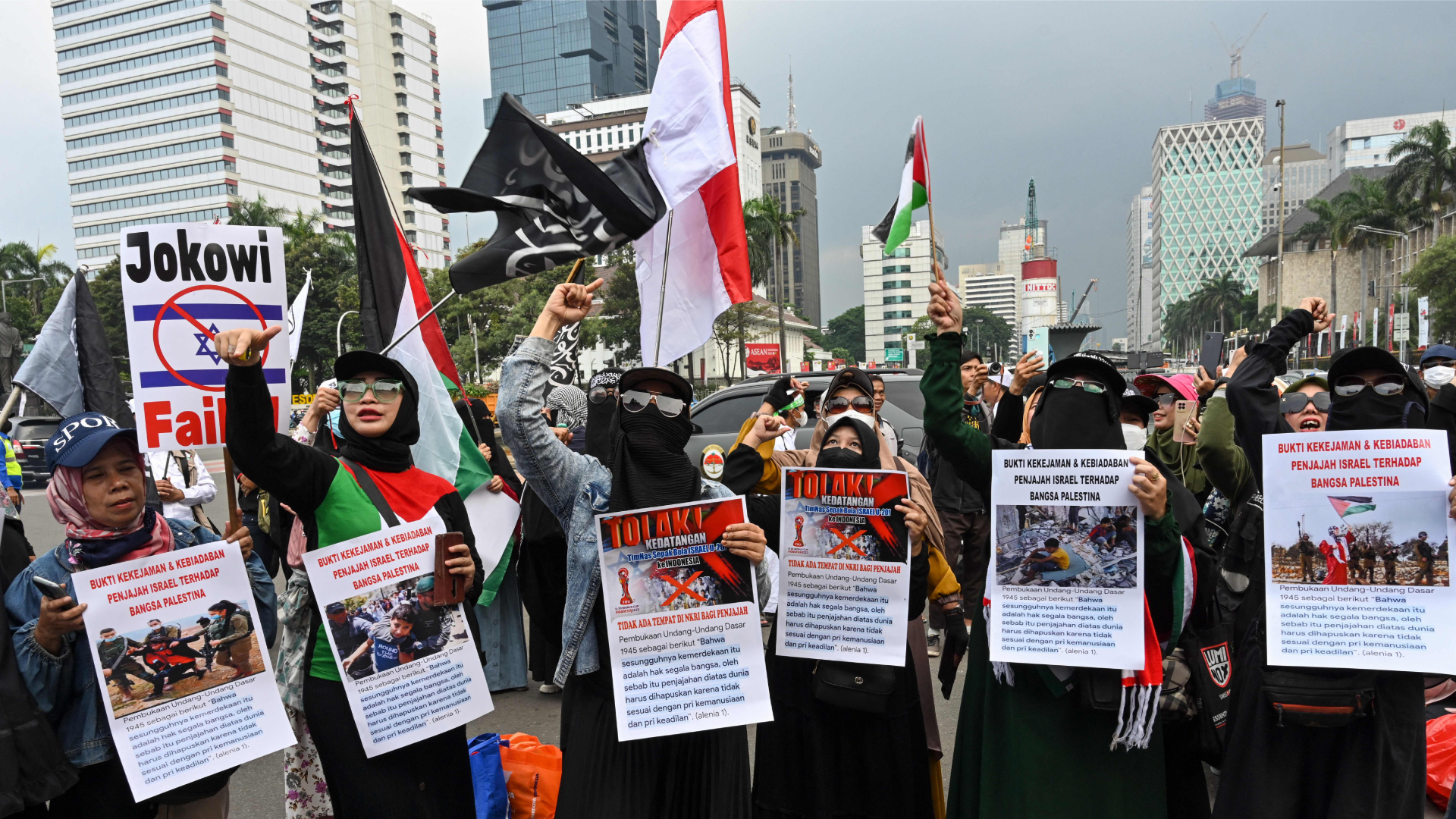 Indonesians carry placards and shout slogans during a rally in Jakarta 03202023