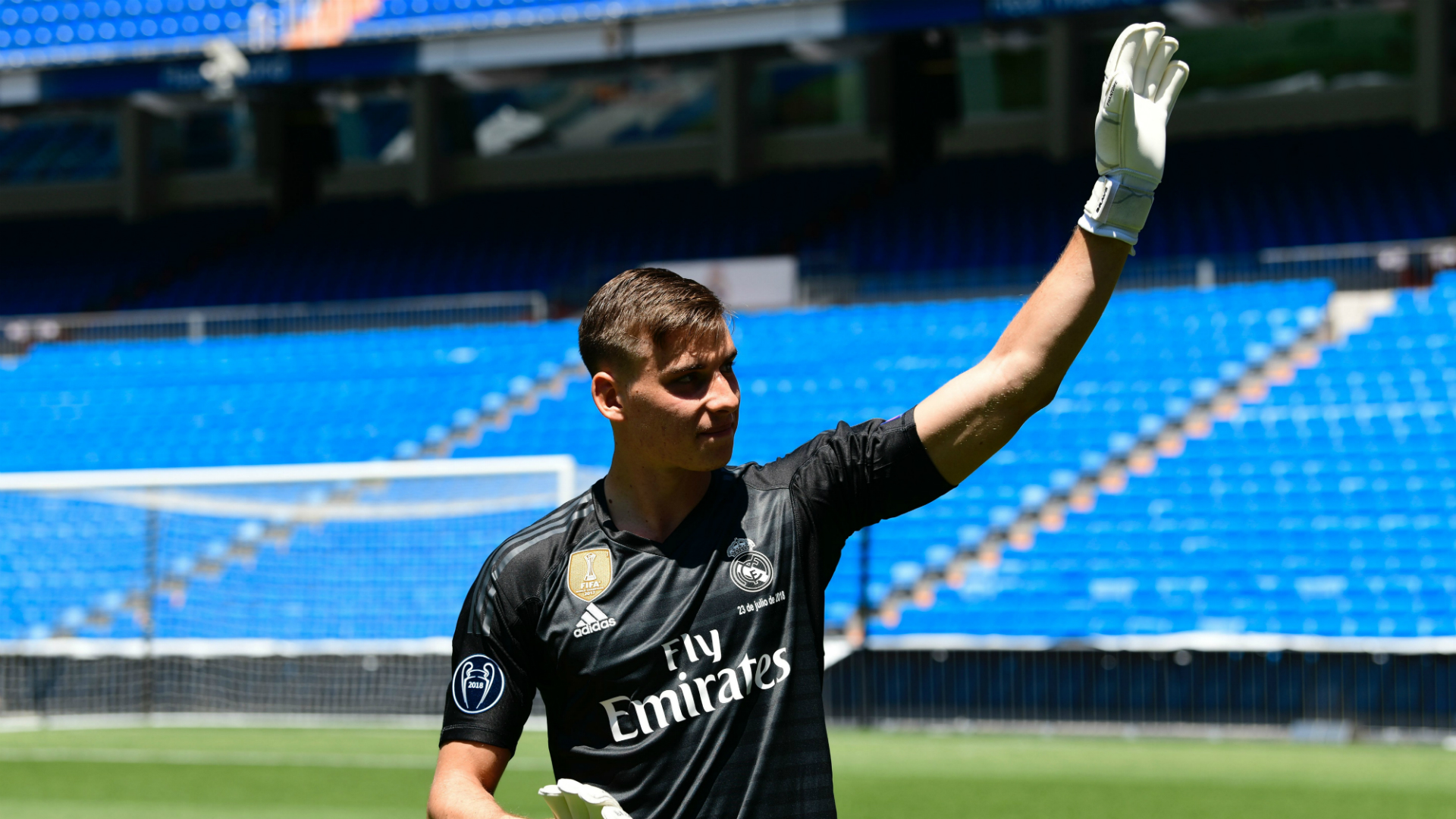 Andriy Lunin waves as he arrives to pose on the pitch during his official presentation at the Santiago Bernabeu Stadium in Madrid 23072018 (Javier Soriano/AFP/Getty Images)
